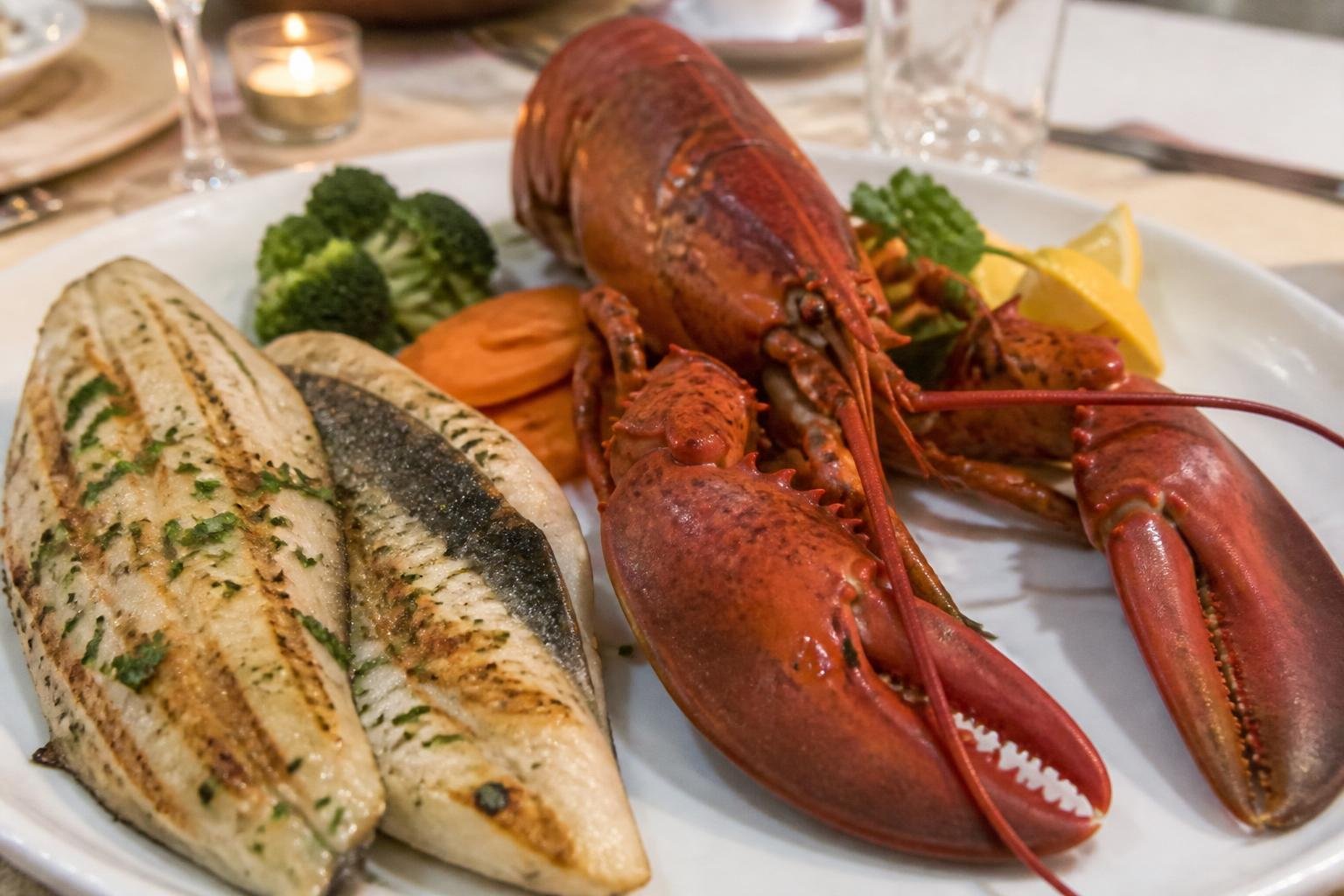 Assiette de homard et poisson frais servis à table